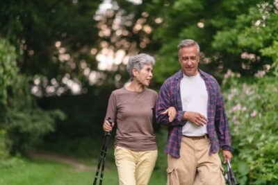 Smiling older couple walking outdoors together on a sunny day