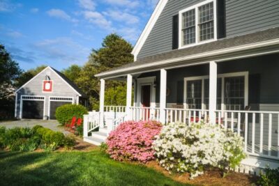 Green house with a well-kept front yard and lush greenery in spring