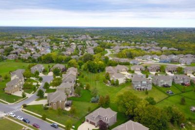 Aerial view of suburban neighborhood representing U.S. housing market forecasts for 2025