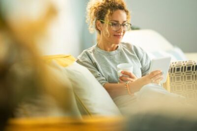 A woman looking at a computer while researching home prices and moving options in the Washington DC, Maryland, and Virginia area.