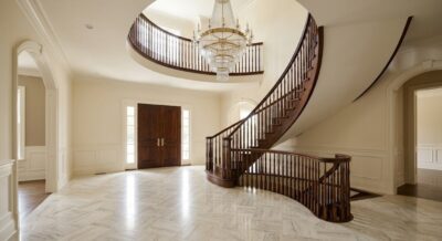 Grand entry hall with curved staircase and marble floor in a McLean Virginia luxury home
