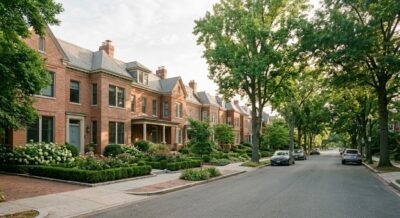 Tree-lined residential street with brick homes and stone walkways in Northwest Washington DC